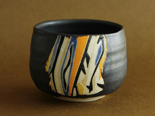 Black-glaze geometric bowl, front view