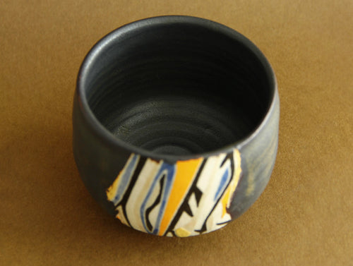 Black-glaze geometric bowl, three-quarter view