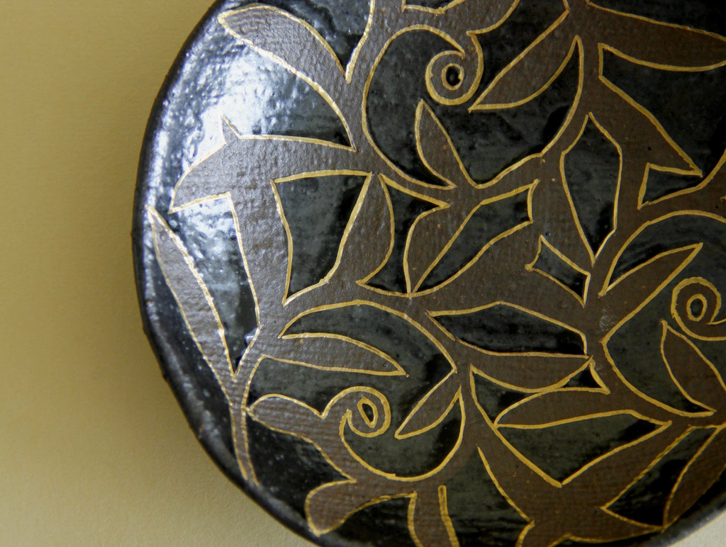 Black-glaze and gilt floral dish, three-quarter view