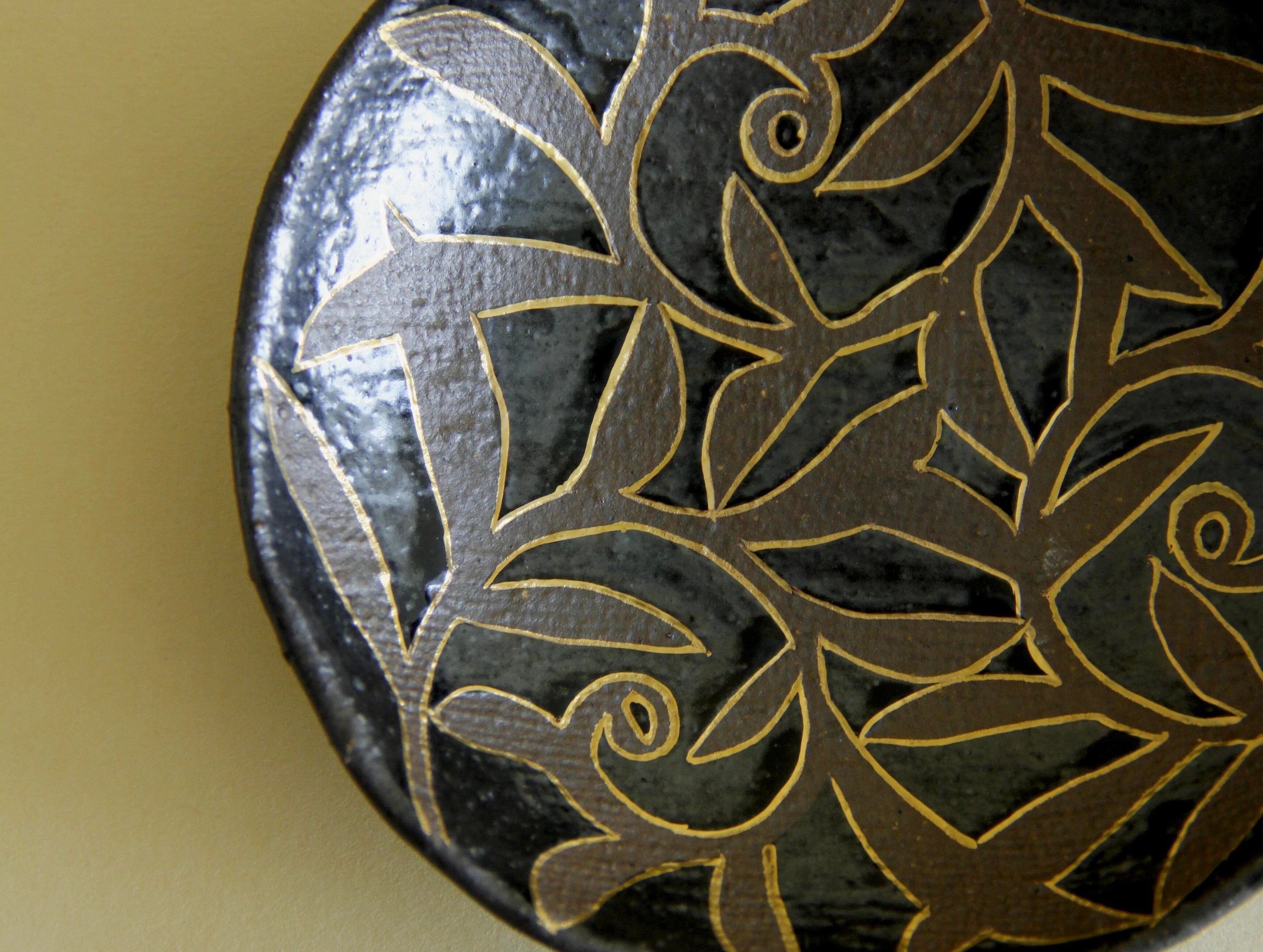 Black-glaze and gilt floral dish, three-quarter view