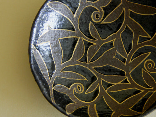 Black-glaze and gilt floral dish, three-quarter view