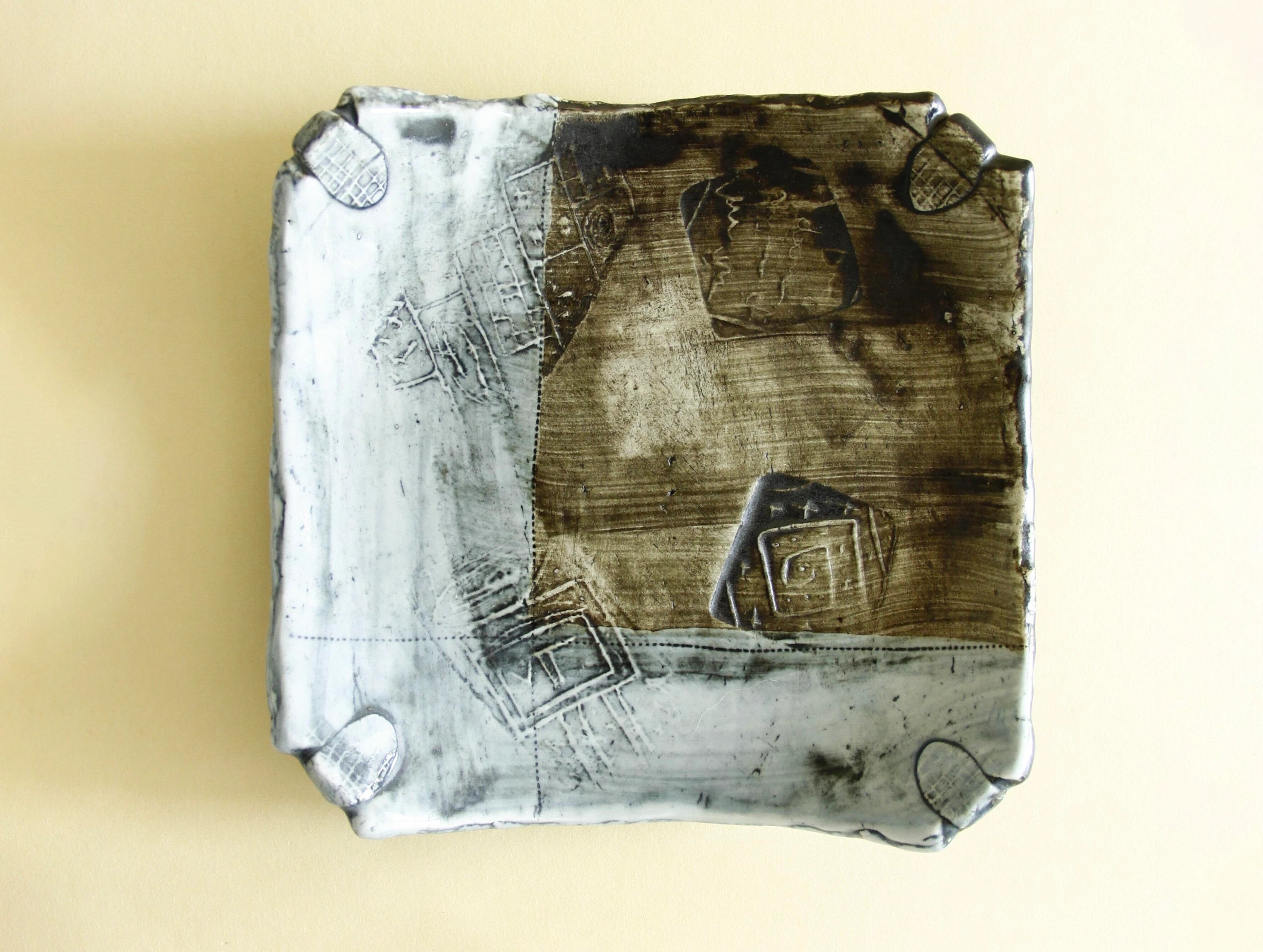 Weathered blue abstract geometric plate, front view