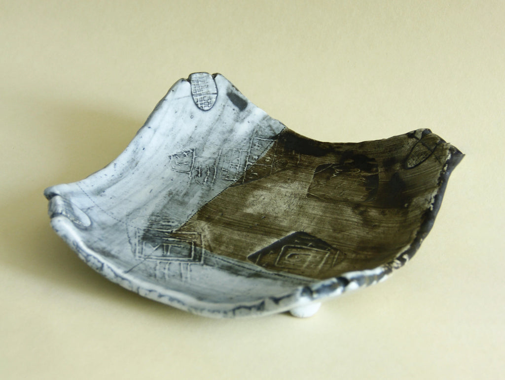 Weathered blue abstract geometric plate, side view