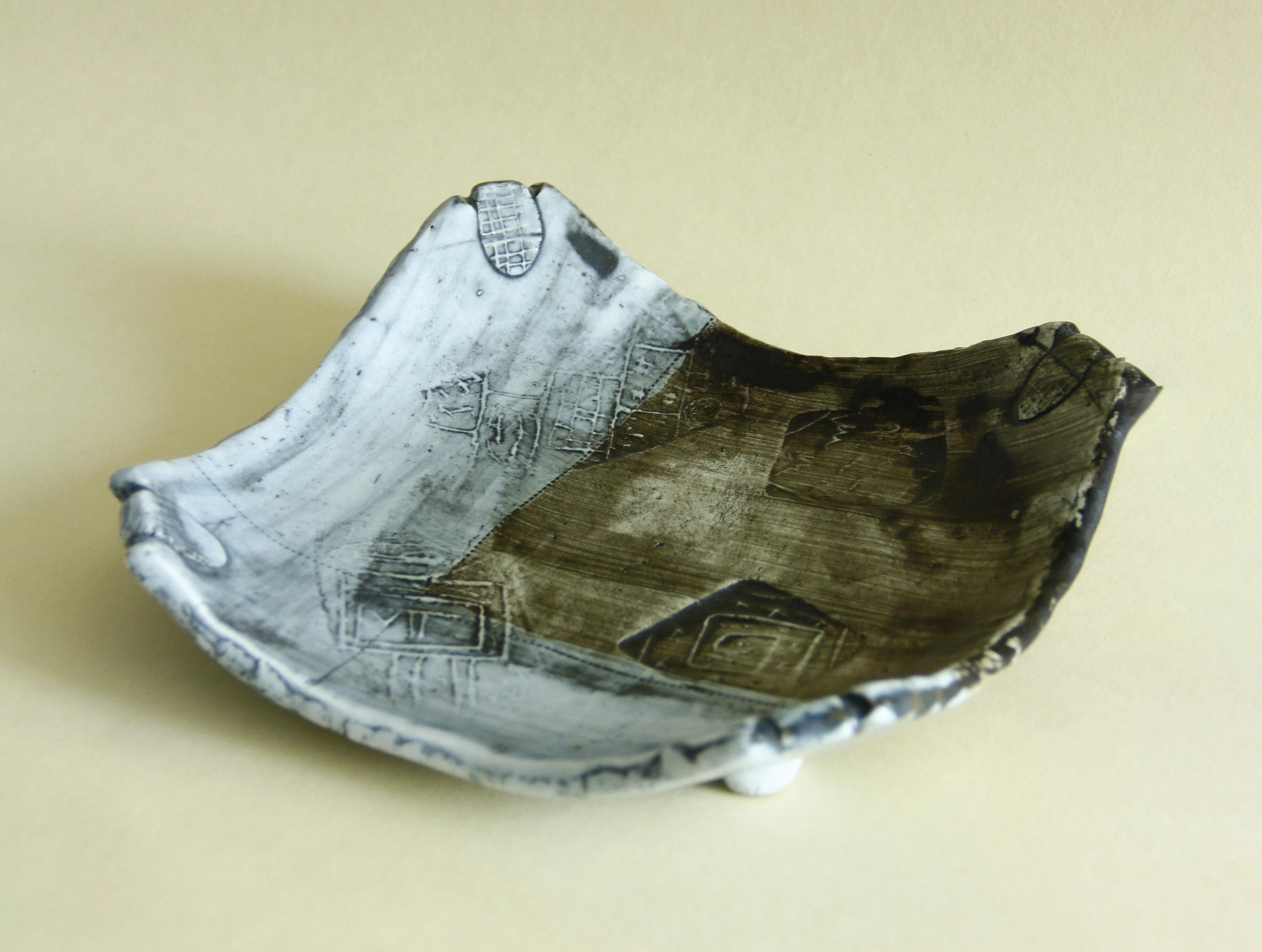 Weathered blue abstract geometric plate, side view